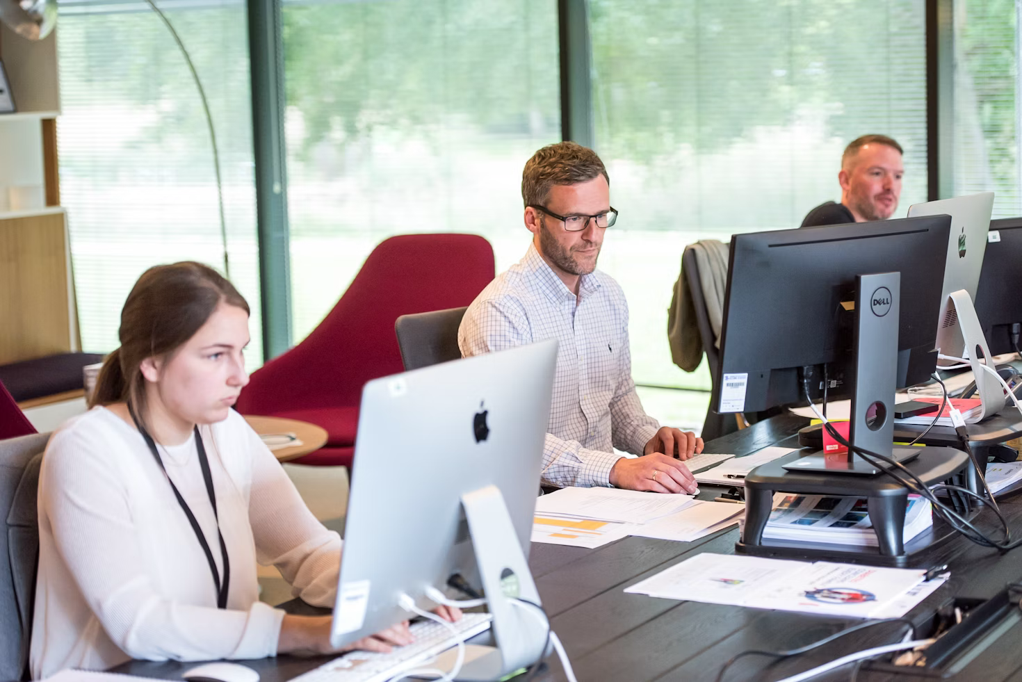 Customer service representatives respond to clients using office computers