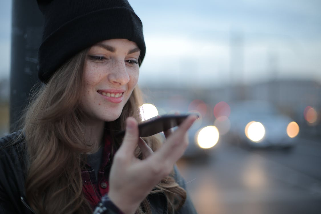 A person using voice search on their phone